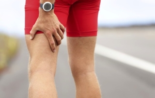 runner holding his leg in pain
