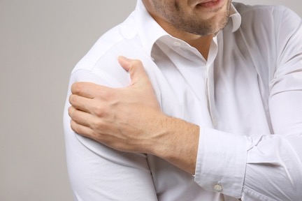Man holding shoulder in pain. 